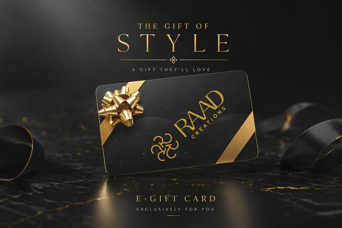 A black and gold e-gift card from RAAD CREATIONS, styled with a metallic gold bow on a dark marble surface with black ribbons, under the text 'THE GIFT OF STYLE'.