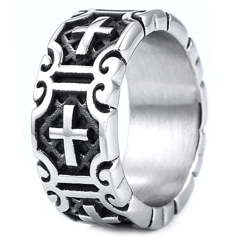 Silver ring with intricate designs and a cross symbol on a white background