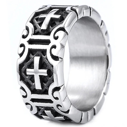 Silver ring with intricate designs and a cross symbol on a white background