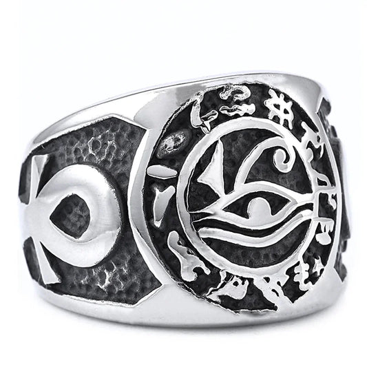 Silver ring with intricate designs on a white background