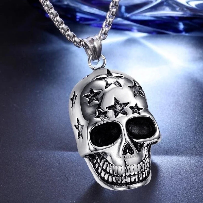 Silver skull pendant with star designs on a reflective surface