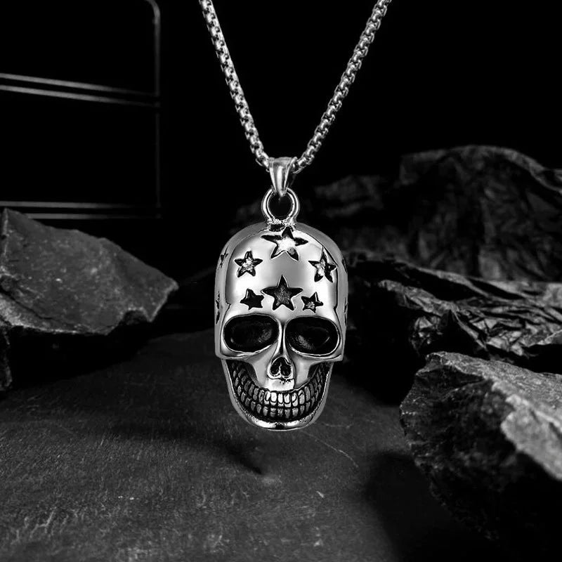 Silver skull pendant necklace with star details on a dark background