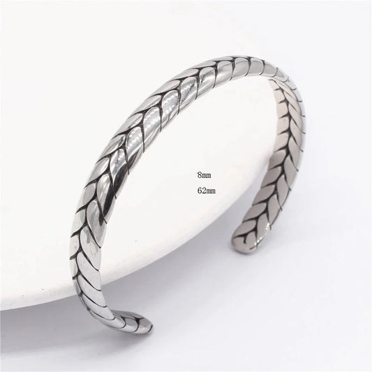 Silver bangle with leaf-like pattern on a white background