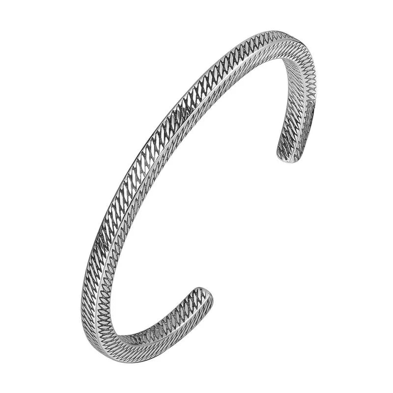 Silver bracelet with textured design on a white background