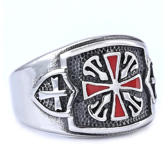 Silver ring with a red and white cross design on a white background