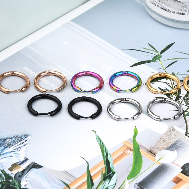 Collection of keychain rings in various colors on a magazine page with plants.