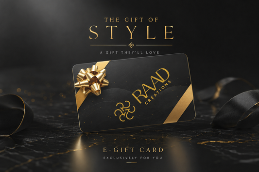 A black and gold e-gift card from RAAD CREATIONS, styled with a metallic gold bow on a dark marble surface with black ribbons, under the text 'THE GIFT OF STYLE'.