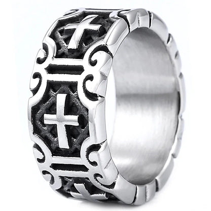 Silver ring with intricate designs and a cross symbol on a white background