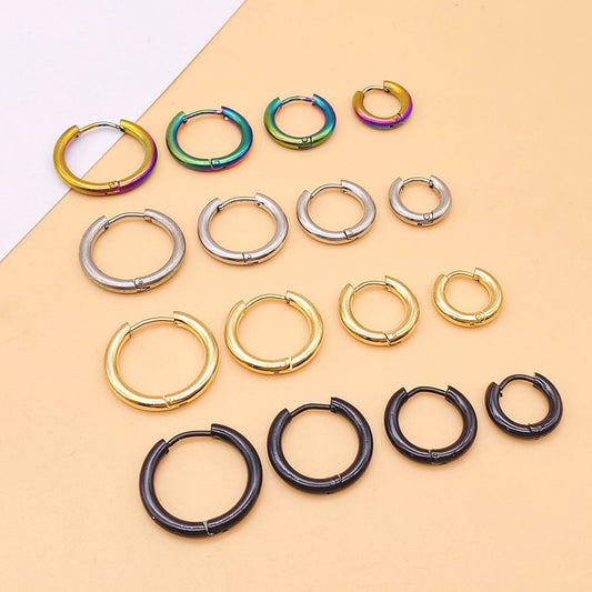 Collection of hoop earrings in various colors on a beige background