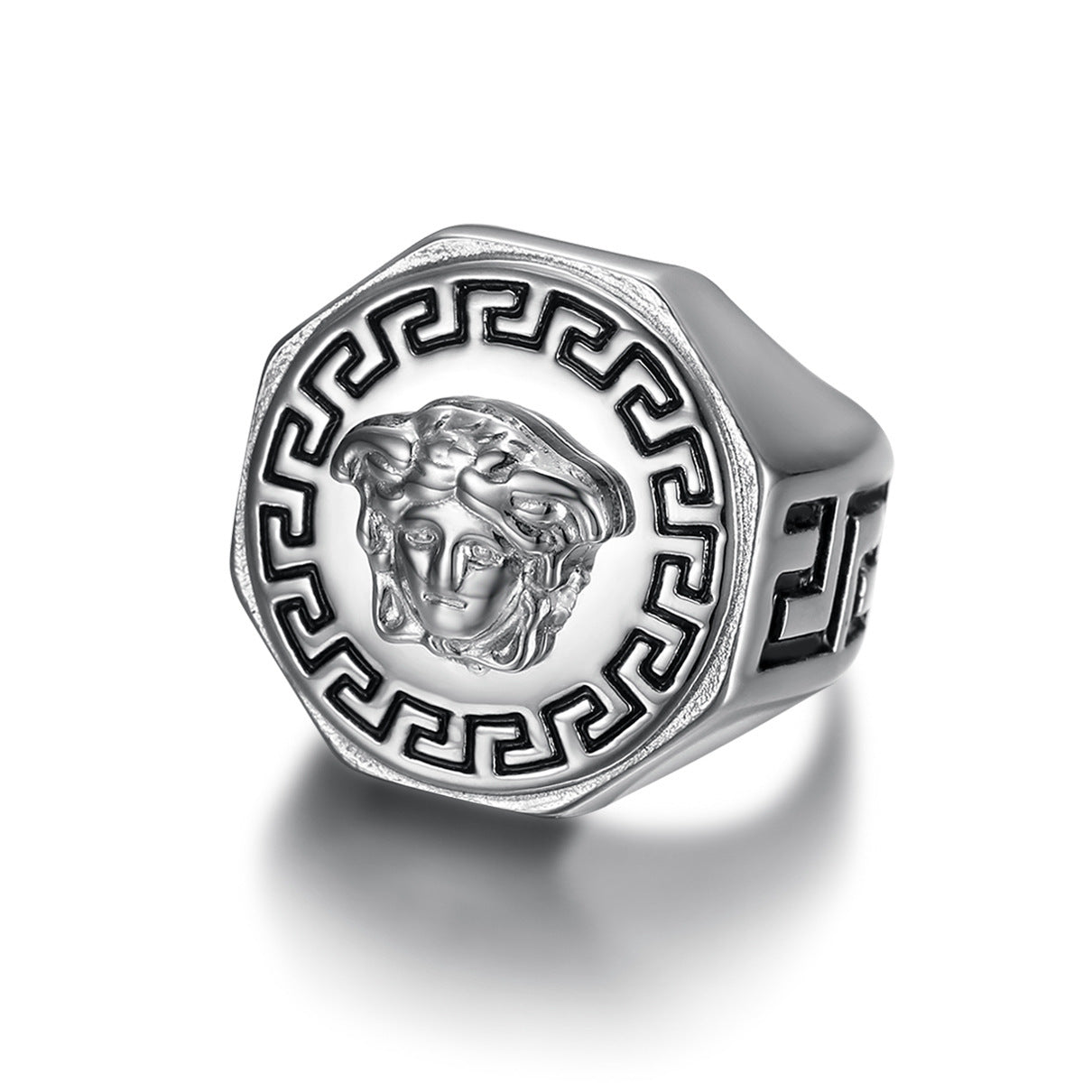 Silver ring with a Medusa head design on a white background