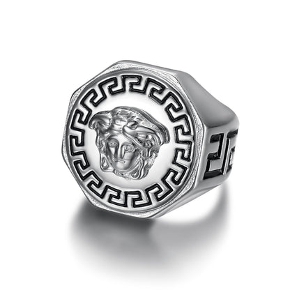 Silver ring with a Medusa head design on a white background