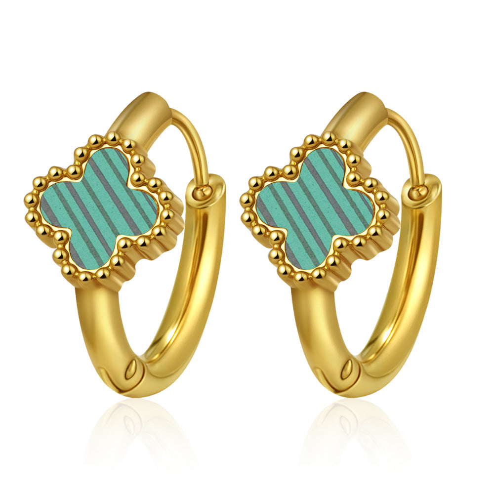 Gold hoop earrings with turquoise clover-shaped stones on a white background