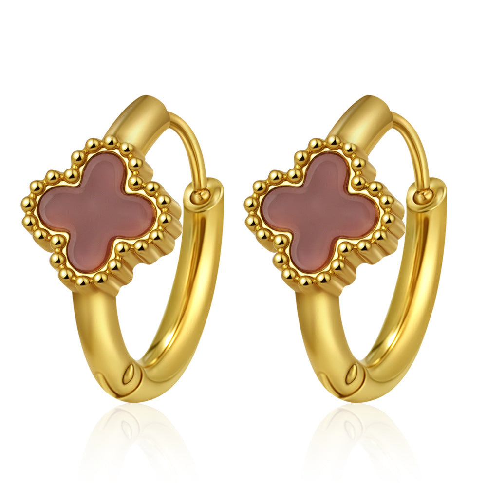 Gold hoop earrings with pink clover-shaped stones on a white background