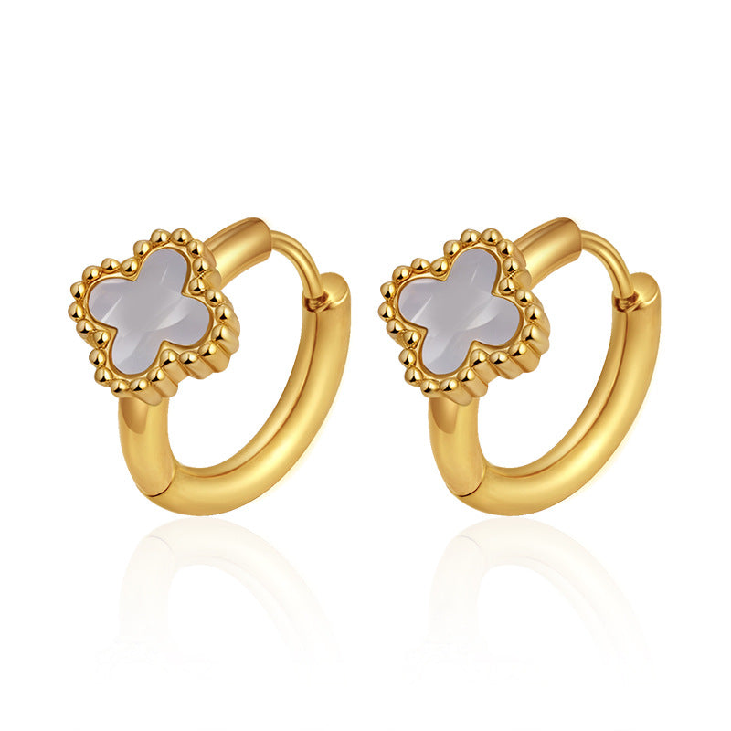 Gold hoop earrings with clover-shaped center on a white background
