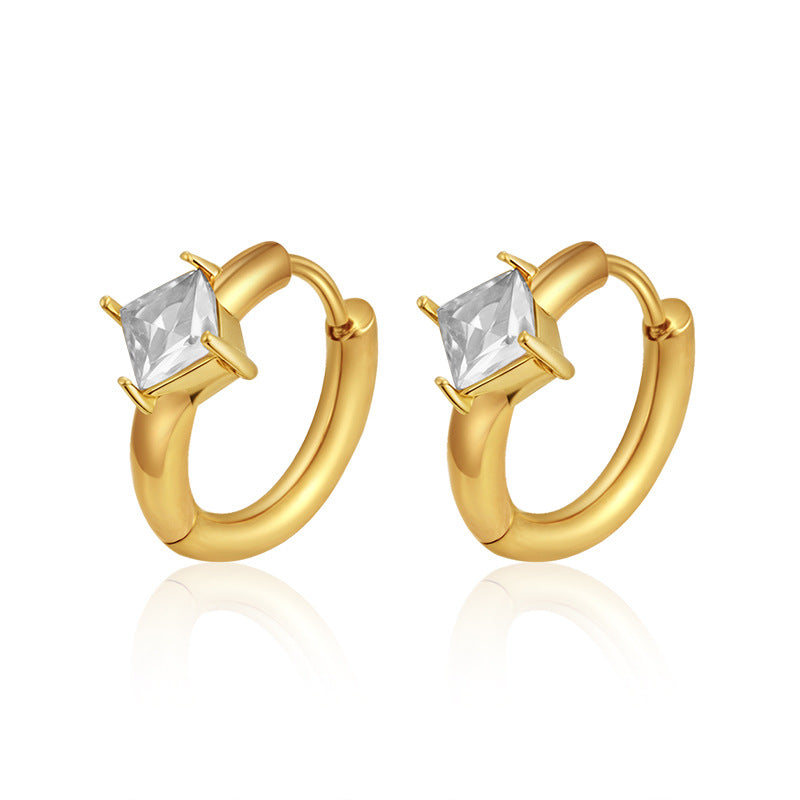 Gold hoop earrings with clear gemstones on a white background