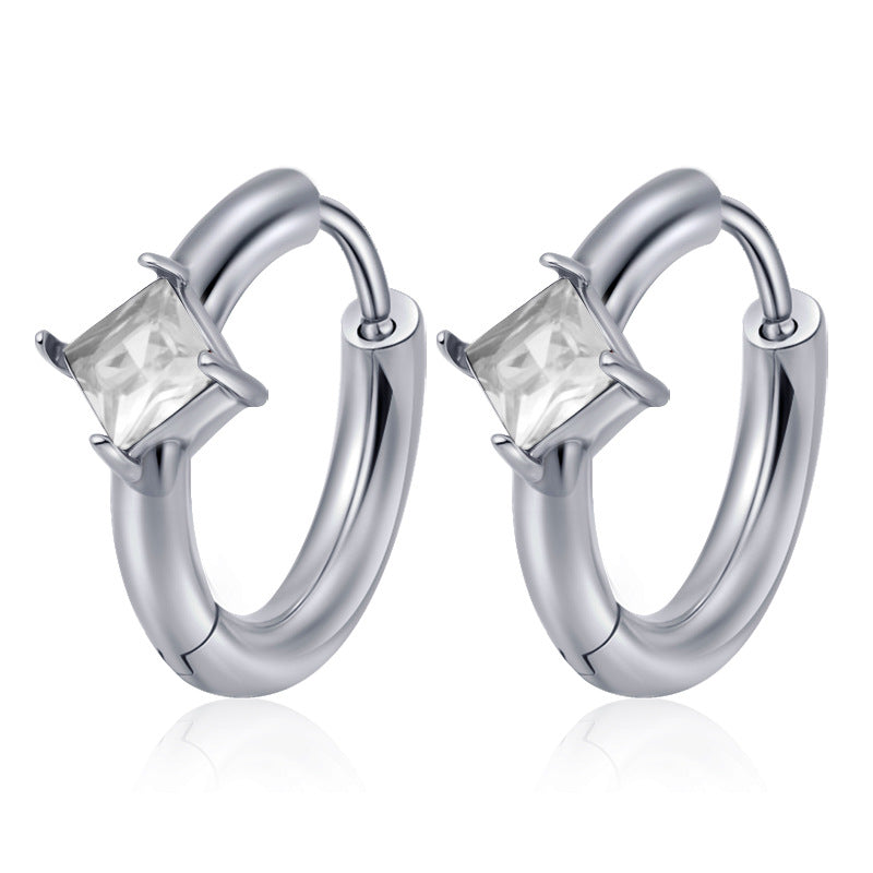 Silver hoop earrings with clear gemstones on a white background