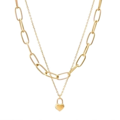 Gold chain necklace with a heart-shaped pendant on a white background