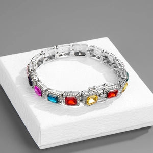 Multicolored gemstone bracelet on a white box with a gray background