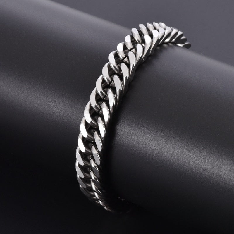 Silver chain bracelet on a dark fabric background