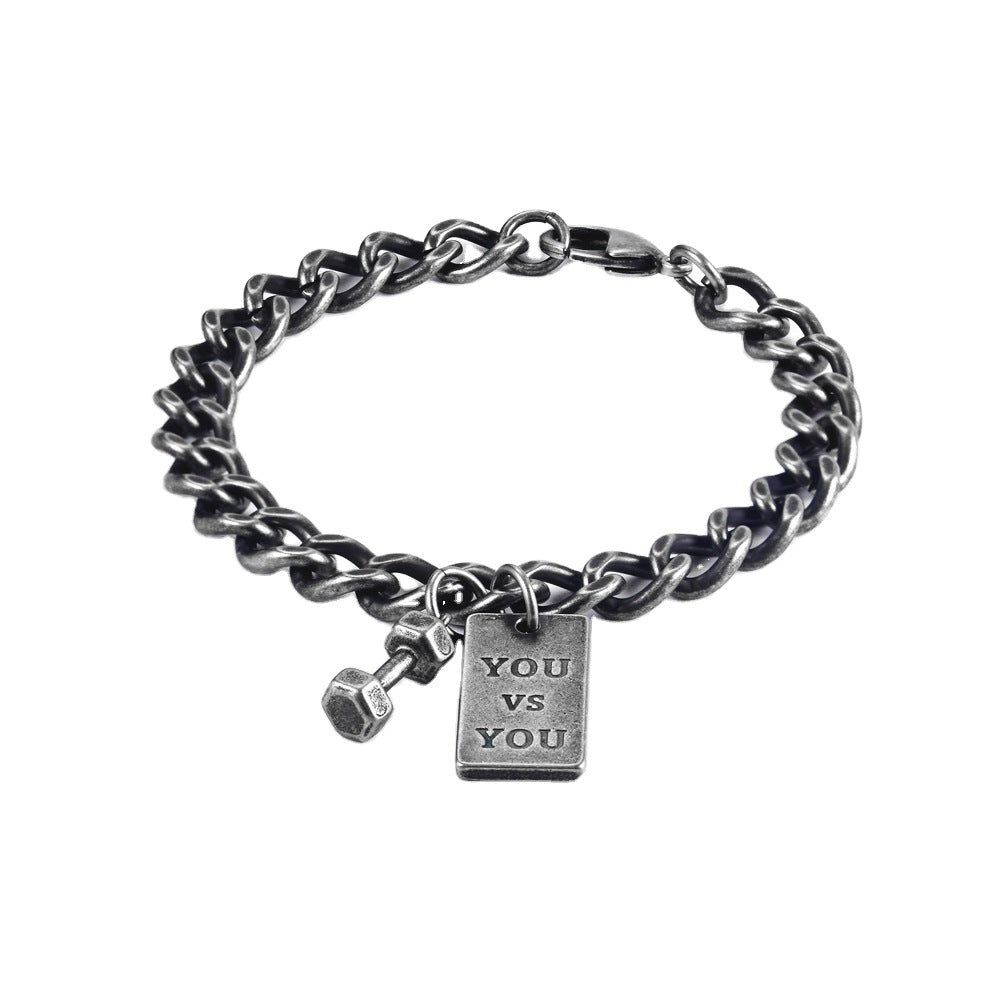 Silver chain bracelet with a 'YOU VS YOU' tag on a white background